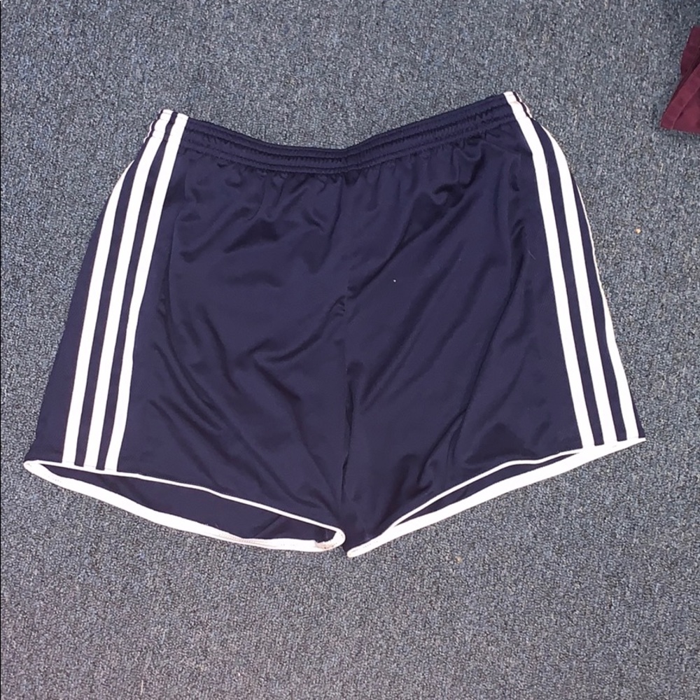 dark blue addidas shorts.